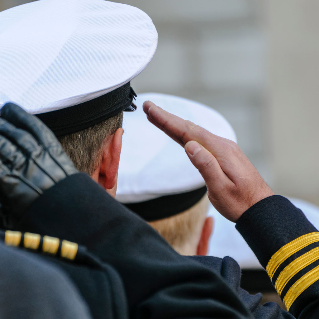 A group of sailors saluting each other.